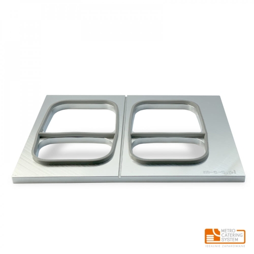 Matryca do zgrzewarek METROOPACK, wykonana z metalu, z dwoma prostokątnymi otworami. Ujęcie frontalne, ukazuje gładką powierzchnię i wykończenie w kolorze srebrnym. Produkt przeznaczony do zgrzewania pojemników T1611.